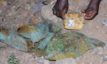 One photograph from the scene of clothing and an ID card left at the scene of the massacre in Mahibere Dego