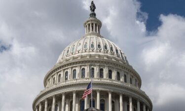 The US flag flies at half-mast on the US Capitol in Washington