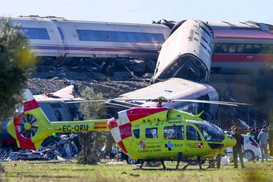 Emergency services work at the scene of a collision between two trains in Urda