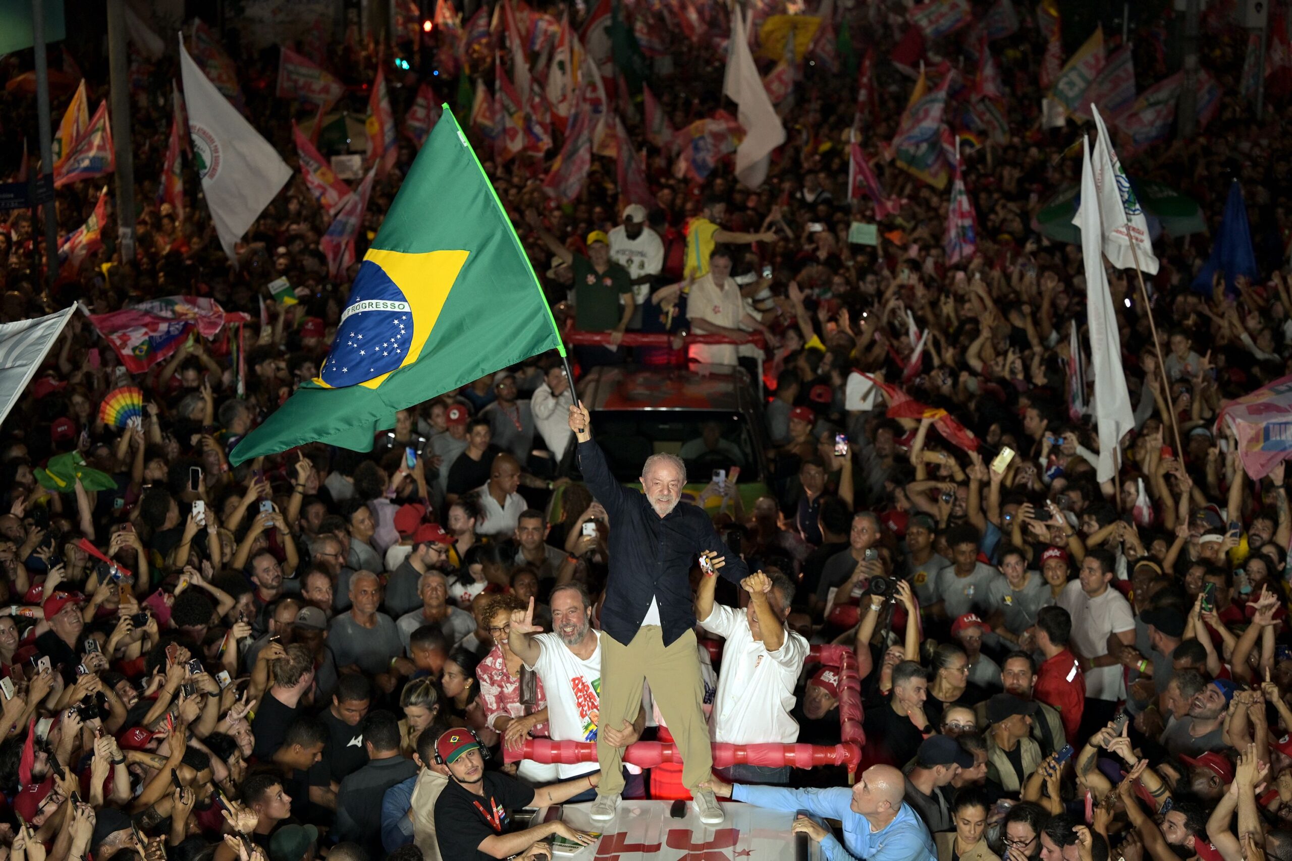A street vendor arranges campaign flags for sale featuring Brazilian President Luiz Inacio Lula da Silva