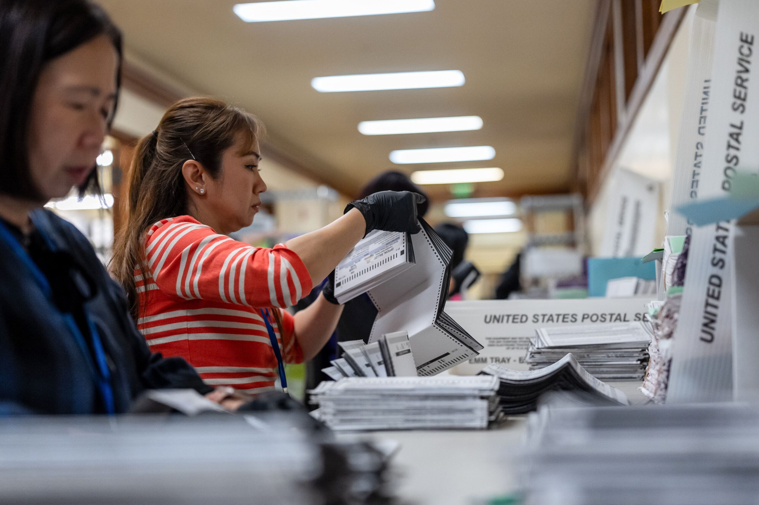 Election workers sort ballots during early voting ahead of the midterm election at San Francisco County's election operations facility at City Hall in San Francisco