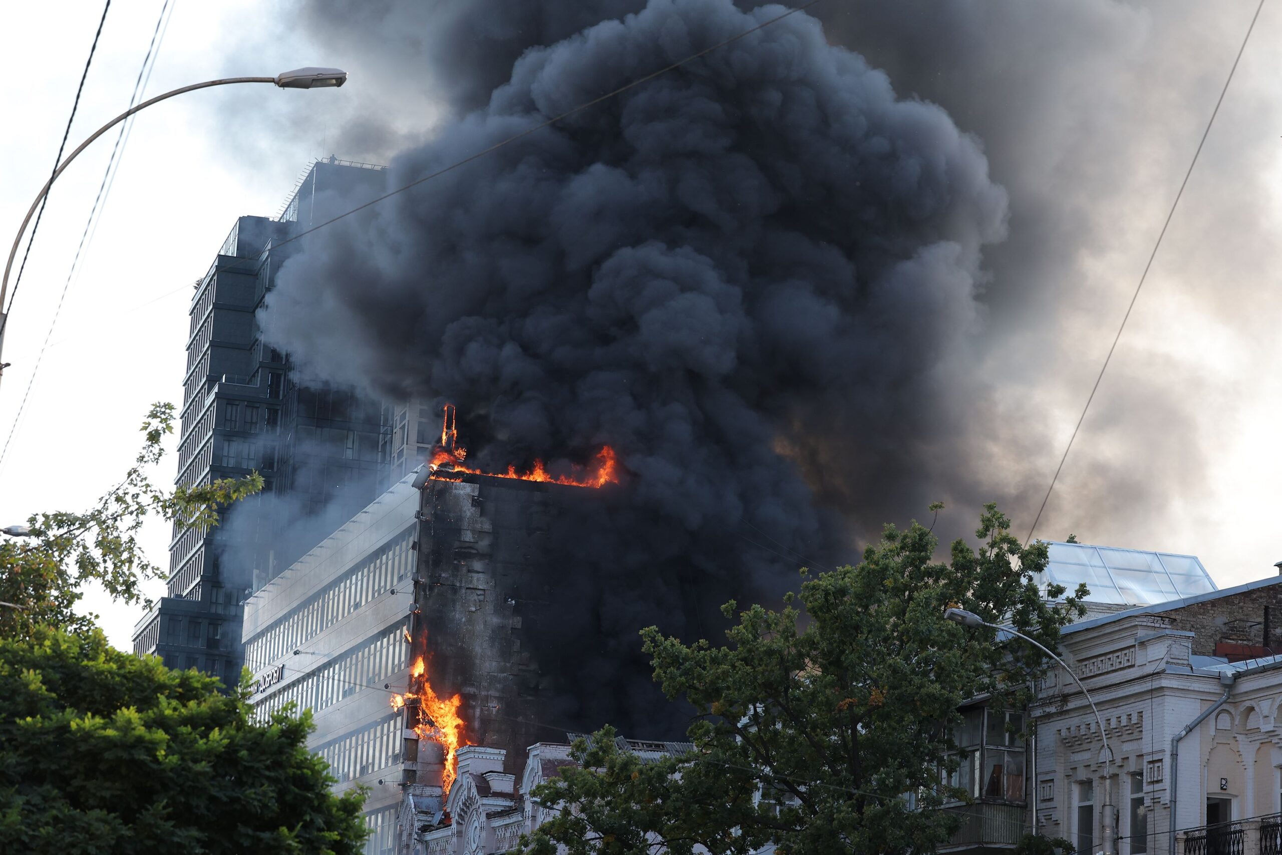 Electricians work to restore the power grid in front of a destroyed private house in the Kyiv region. A a 14-year-old was killed in the attack on September 30.